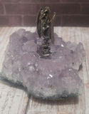 Pewter figurine on rough gemstone