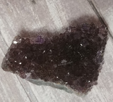 Heart Shaped Amethyst Gemstone on wood grain background GGandJ.com