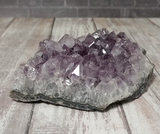 Purple Amethyst on Wood Grain Background