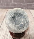 Celestite Gemstone from Madagascar Sphere on wood grain