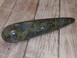Carved Gemstone Wand on Wood Grain background