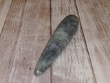 Carved Gemstone Wand on Wood Grain background