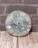 Celestite Gemstone from Madagascar Sphere on wood grain