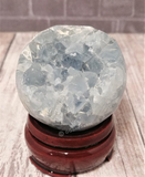 Celestite Sphere on wood stand natural blue gemstone