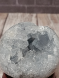 half carved half rough gemstone sphere blue celestite from madagascar