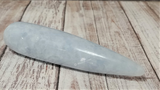 Celestite Gemstone from Madagascar Wand on wood grain