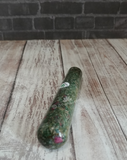Ruby Fushite wand on wood grain background