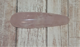 Natural Rose Quartz Gemstone Massage wand on wood grain background