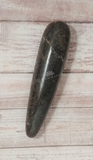 Moonstone massage wand on wood grain background