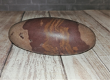 River Stone Shiva Lingam on natural wood background GGandJ.com