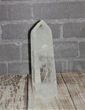 Clear Quartz wand on wood grain background GGandJ.com
