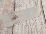 Clear Quartz Tower on wood grain background
