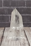 Clear Quartz Tower on wood grain background