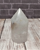 Brazilian Agate carved tower on wood grain and brick background