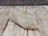 Brazilian Agate carved tower on wood grain and brick background