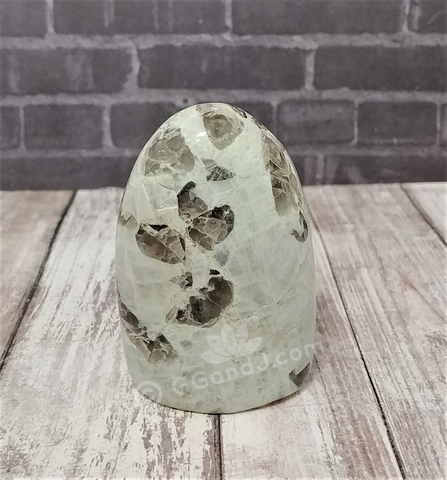 Garnierite cut base free form tower with wood grain and brick background Gypsy Gems & Jewelry GGandJ.com Naturally Unique