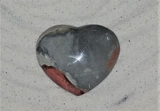 Jasper heart on sand background ggandj.com