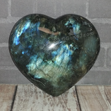 Iridescent gemstone heart on wood grain background Labradorite from Madagascar GGandJ.com