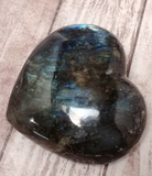 Hand carved gemstone heart from Madagascar on Wood grain background