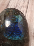 Iridescent gemstone heart on wood grain background Labradorite from Madagascar GGandJ.com