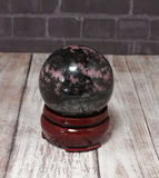 Natural Gemstone Sphere on brick and wood grain background handmade gift idea