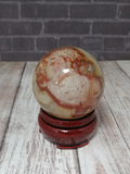 hand carved gemstone sphere on wood stand GGandJ.com