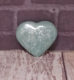 Hand carved gemstone heart from Madagascar on Wood grain background
