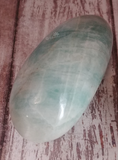 Amazonite gallet from Madagascar on wood grain background