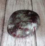 Hand carved gemstone gallet on wood grain background