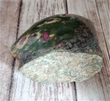 Hand carved gemstone slab from India on Wood grain background