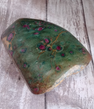Ruby Fushite slab on wood grain background