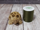 Hand carved soapstone turtle with thread spool size reference
