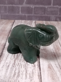 Hand carved Aventurine gemstone Elephant from India on Wood grain background