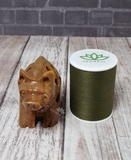 Handcarved gemstone wolf with thread spool size reference Gypsy Gems & Jewelry