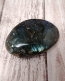 Hand carved gemstone gallet on wood grain background