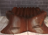 front view of indonesian hand carved hand shaped bowl