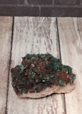 green and pink Moroccan Crystal with wood grain background