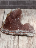 Purple and Pink Amethyst on Wood Grain Background