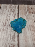 blue Chrysocolla on wood grain background