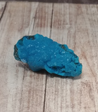 blue Chrysocolla on wood grain background