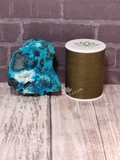 Chrysocolla mineral from Mozambique with thread spool size reference on GGandJ.com Naturally Unique