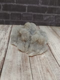Chalcedony with Apophyllite on wood grain and brick background