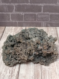 Chalcedony with Apophyllite on wood grain and brick background