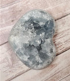 Celestite Gemstone from Madagascar heart on wood grain