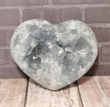Celestite Gemstone from Madagascar heart on wood grain