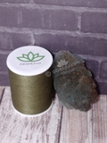 Fluorite with pyrite and size reference thread spool wood grain background