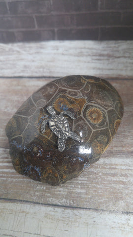 Pewter sea turtle figurine on polished fossil coral