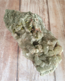 Green gemstone mineral Prehnite on Wood grain background Gypsy Gems & Jewelry