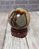 Gemstone Sphere Yellow Brown and Gray on Wood stand brick and woodgrain background GGandJ.com