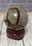 Gemstone Sphere Yellow Brown and Gray on Wood stand brick and woodgrain background GGandJ.com